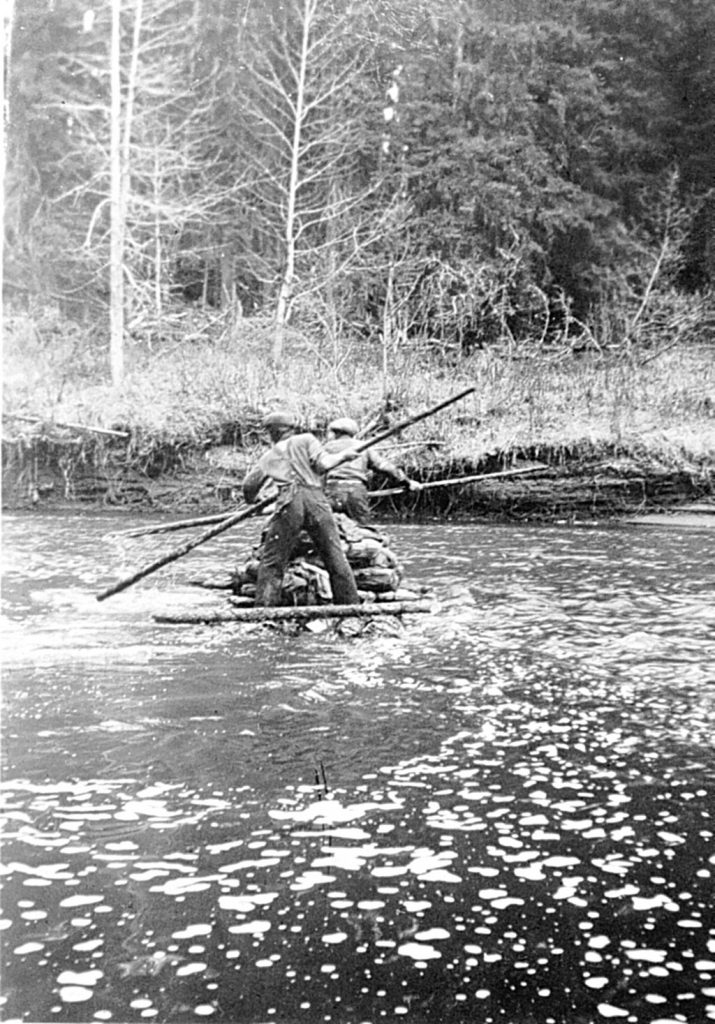 Gene Walters and Andy crossing a river by raft